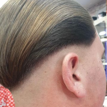 Precision haircut by a skilled London mobile barber with a straight razor finish